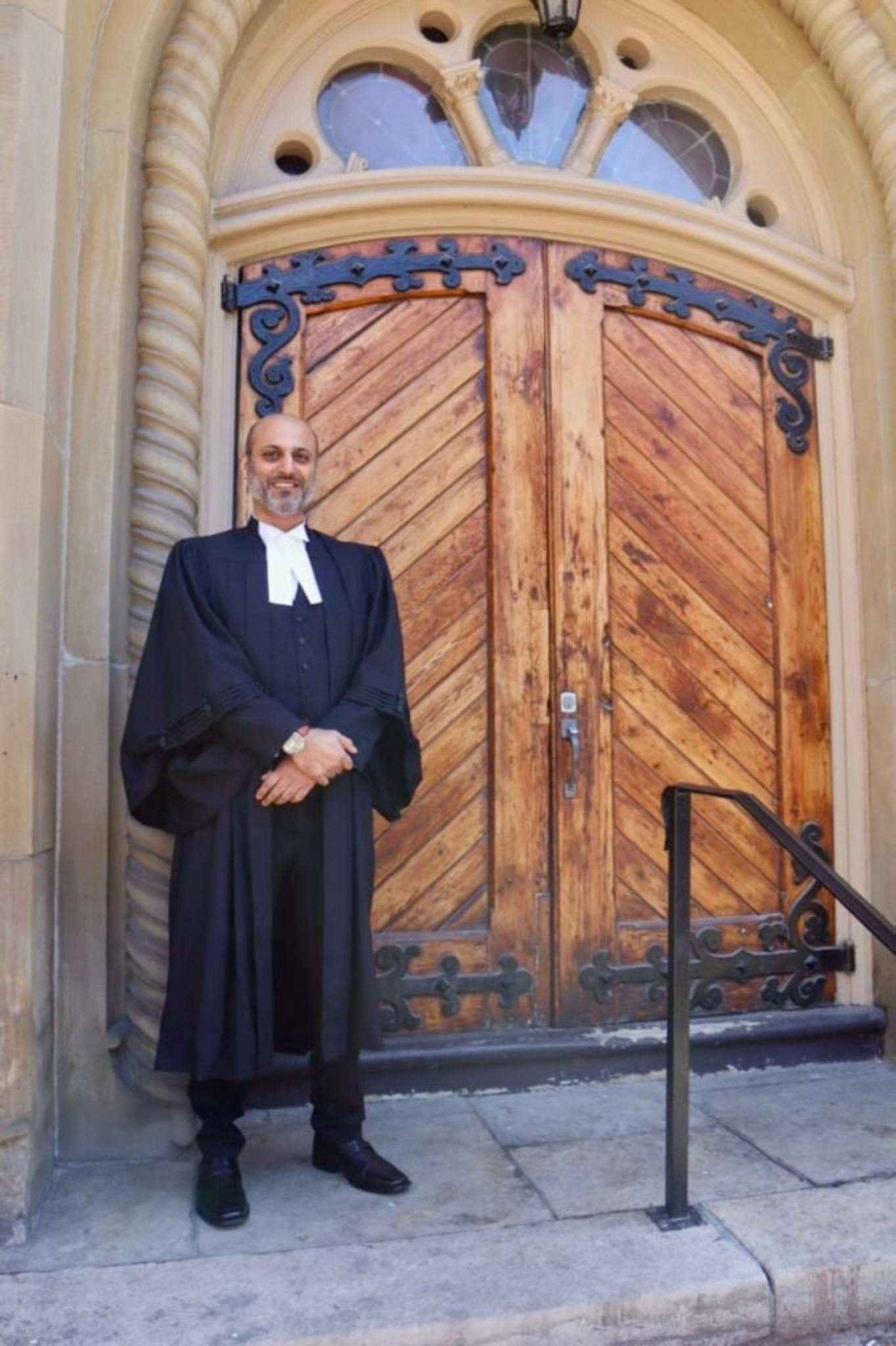 M. Hussain Chaudhry, criminal defense lawyer, standing outside the court in professional attire.

